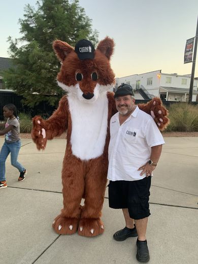 Man and fox taking a pic in matching hats