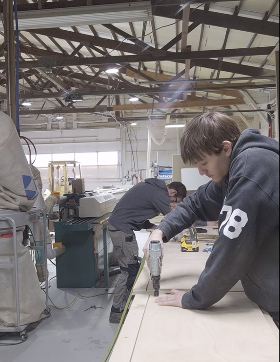 2 guys using powertools to build a entertainment center base