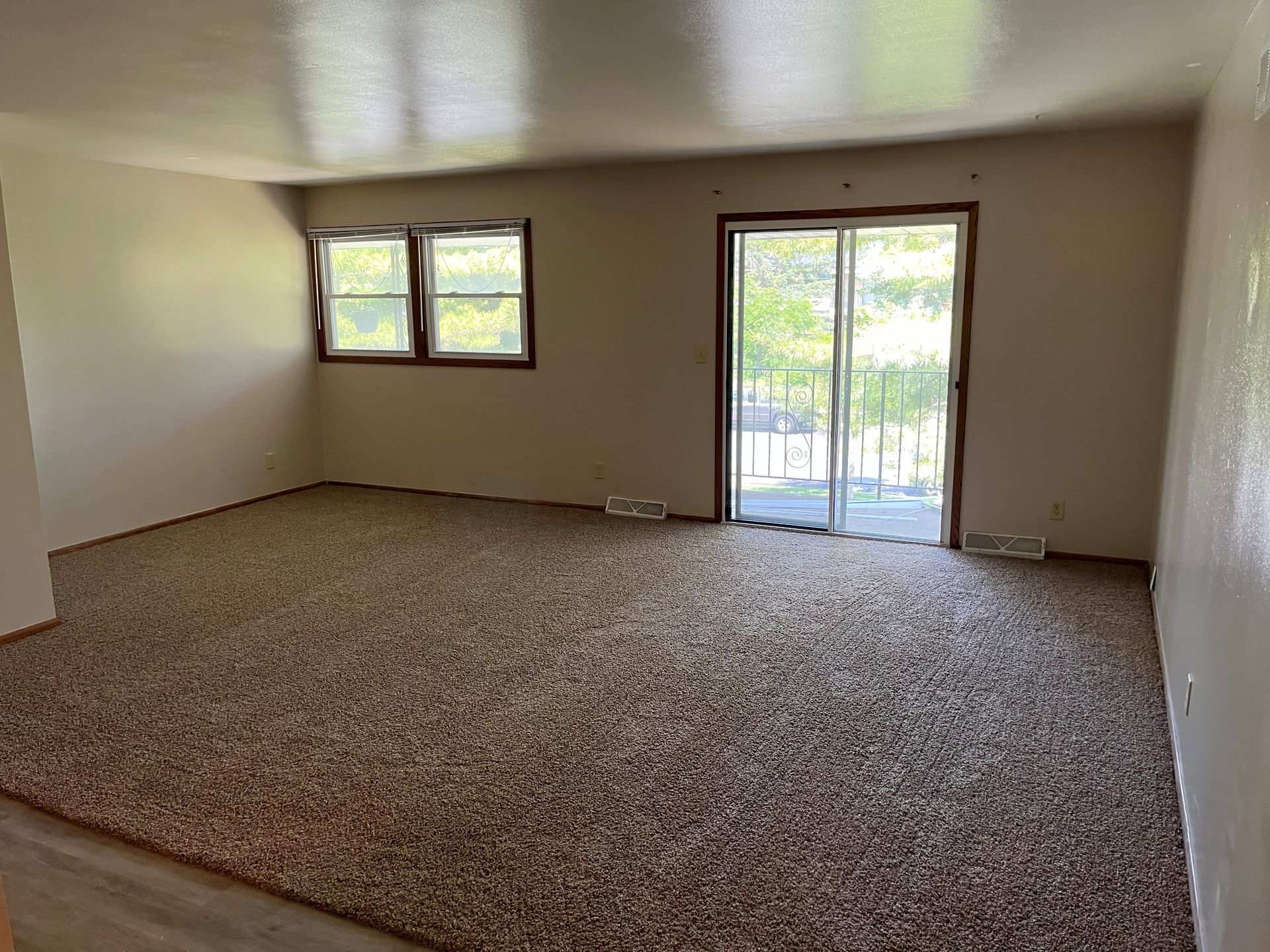 A view of the indoor pool at Rustic Woods townhomes with picnic tables in the back