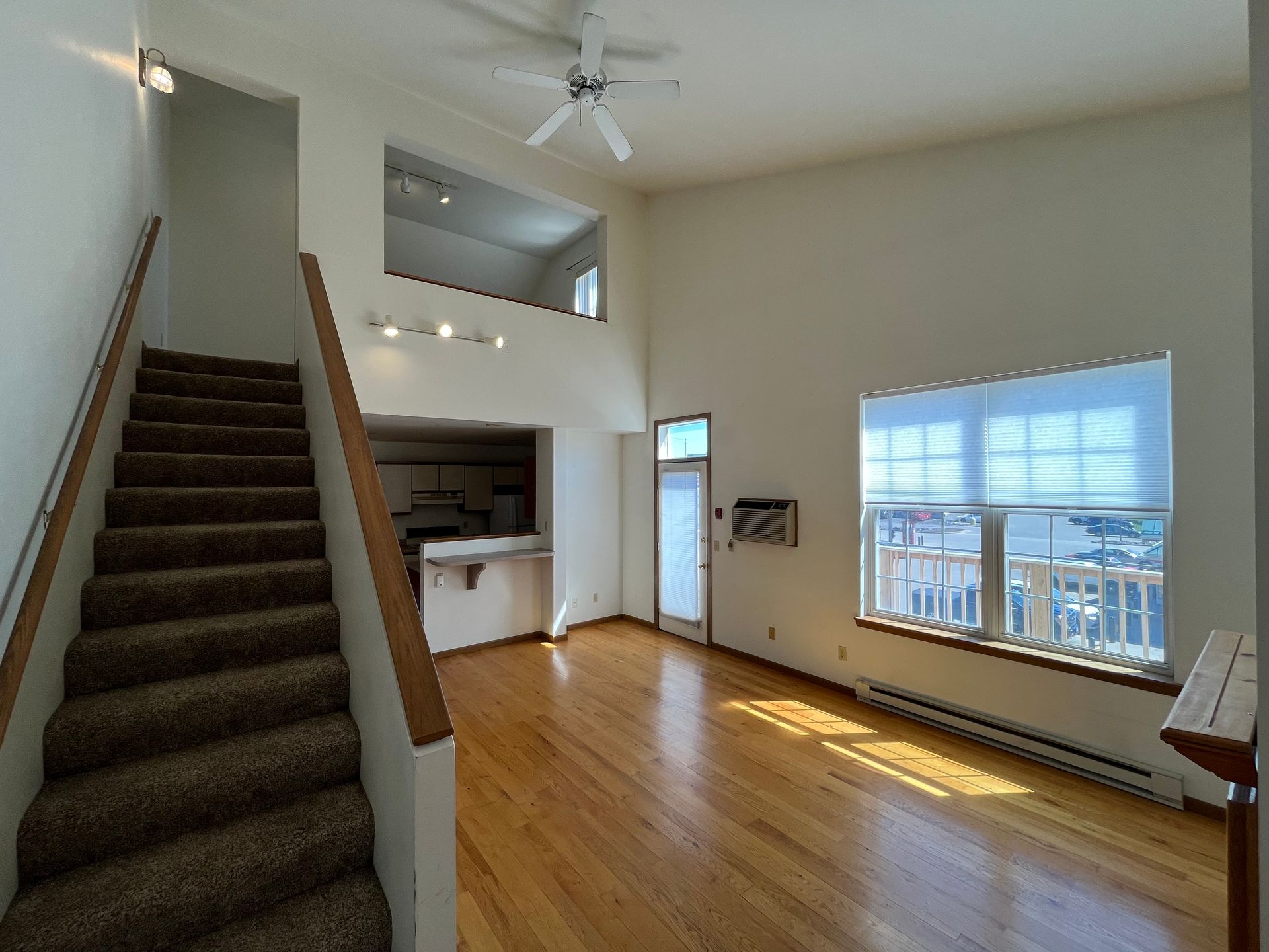The club house at Rustic Woods Townhomes includes a brick fire place, tables, chairs, and full kitchen