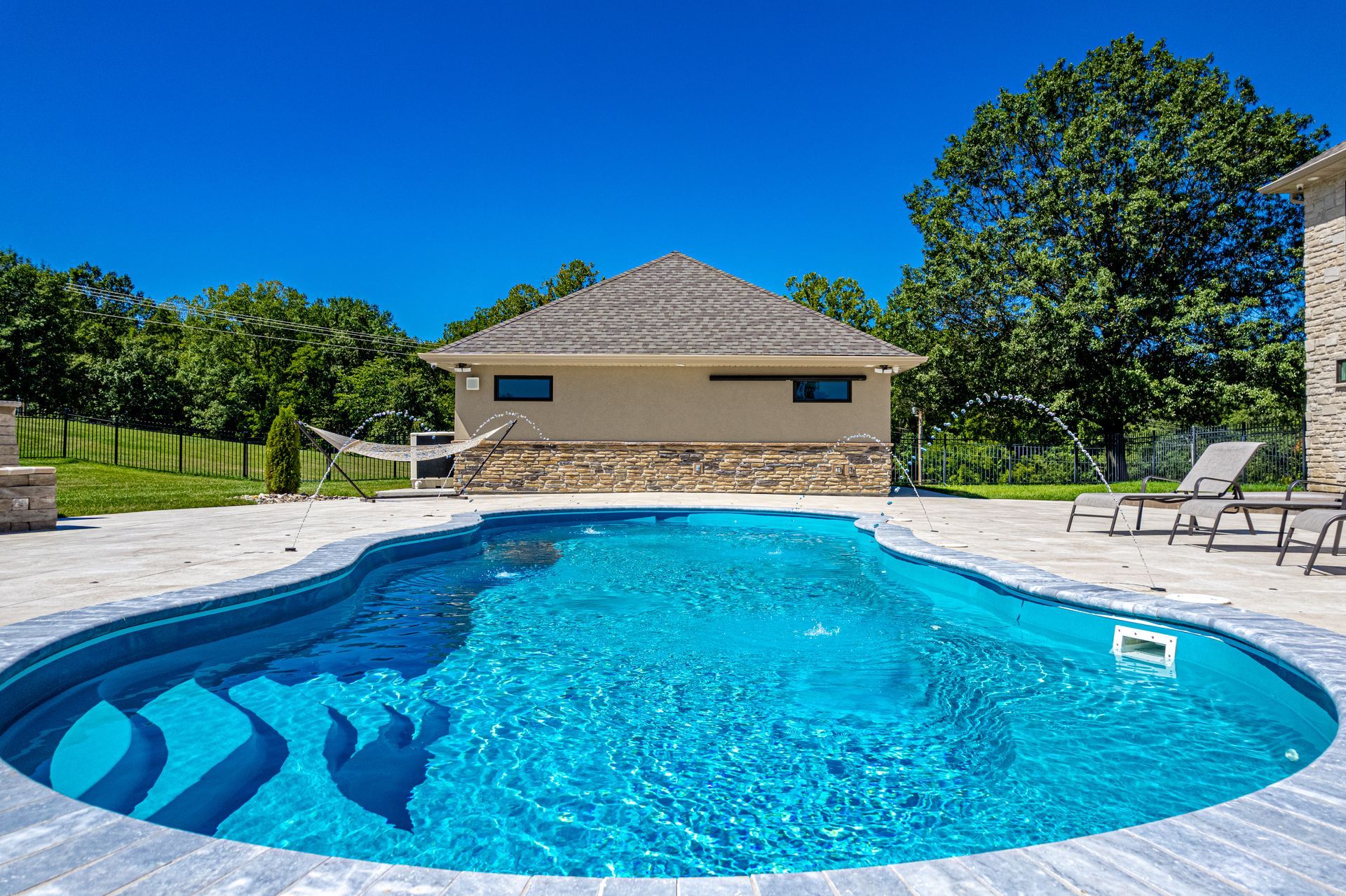 a large swimming pool with a gazebo in the background