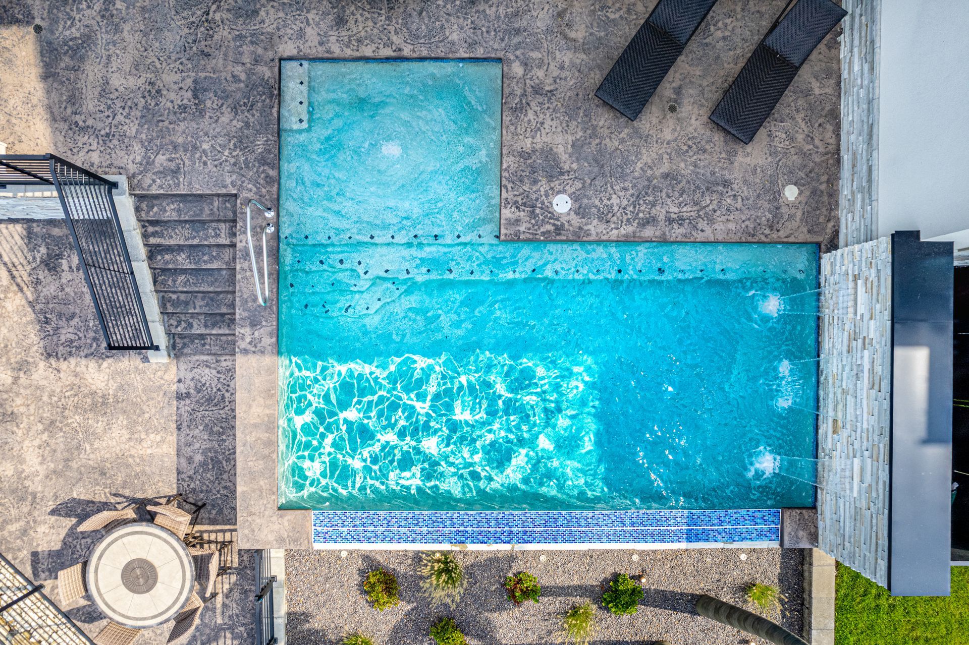 An aerial view of a large swimming pool in a backyard.