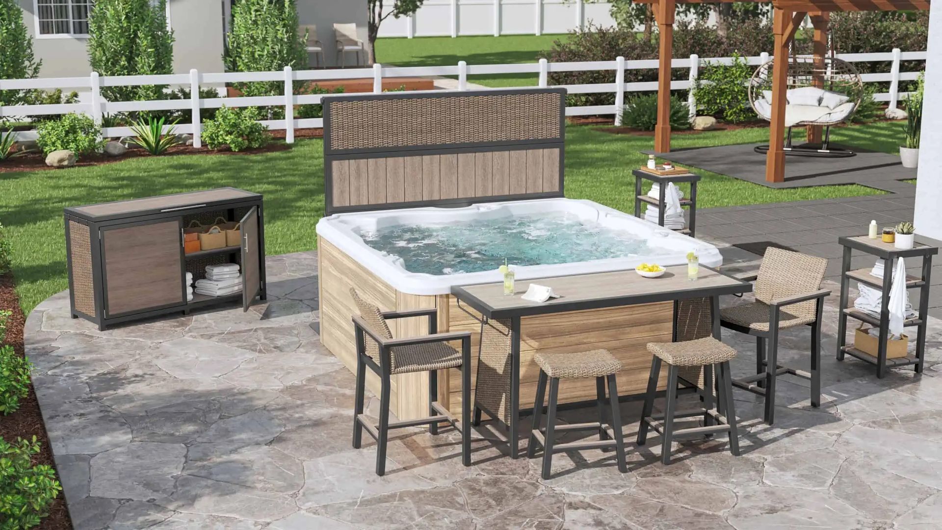 Outdoor patio with a hot tub, dining table, chairs, and a grill on a stone terrace.
