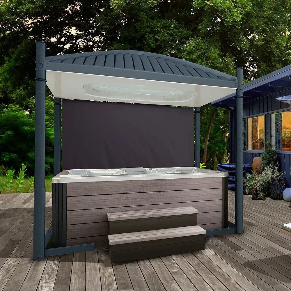 Outdoor hot tub gazebo with dark wood steps and gray roof on a deck, surrounded by greenery