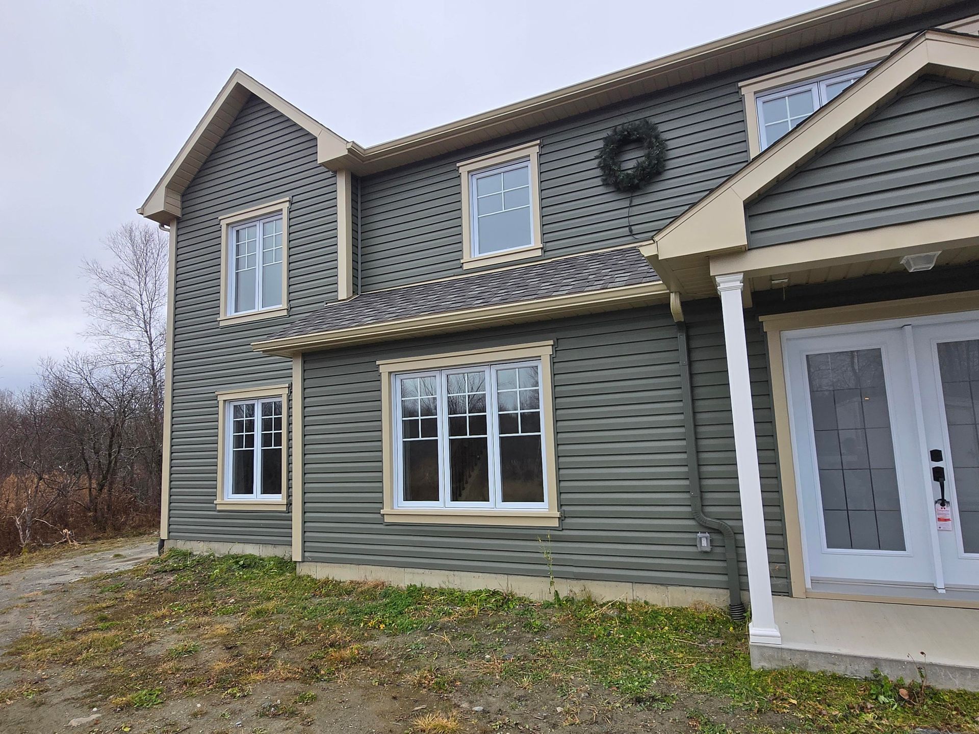 A large house with a wreath on the front of it