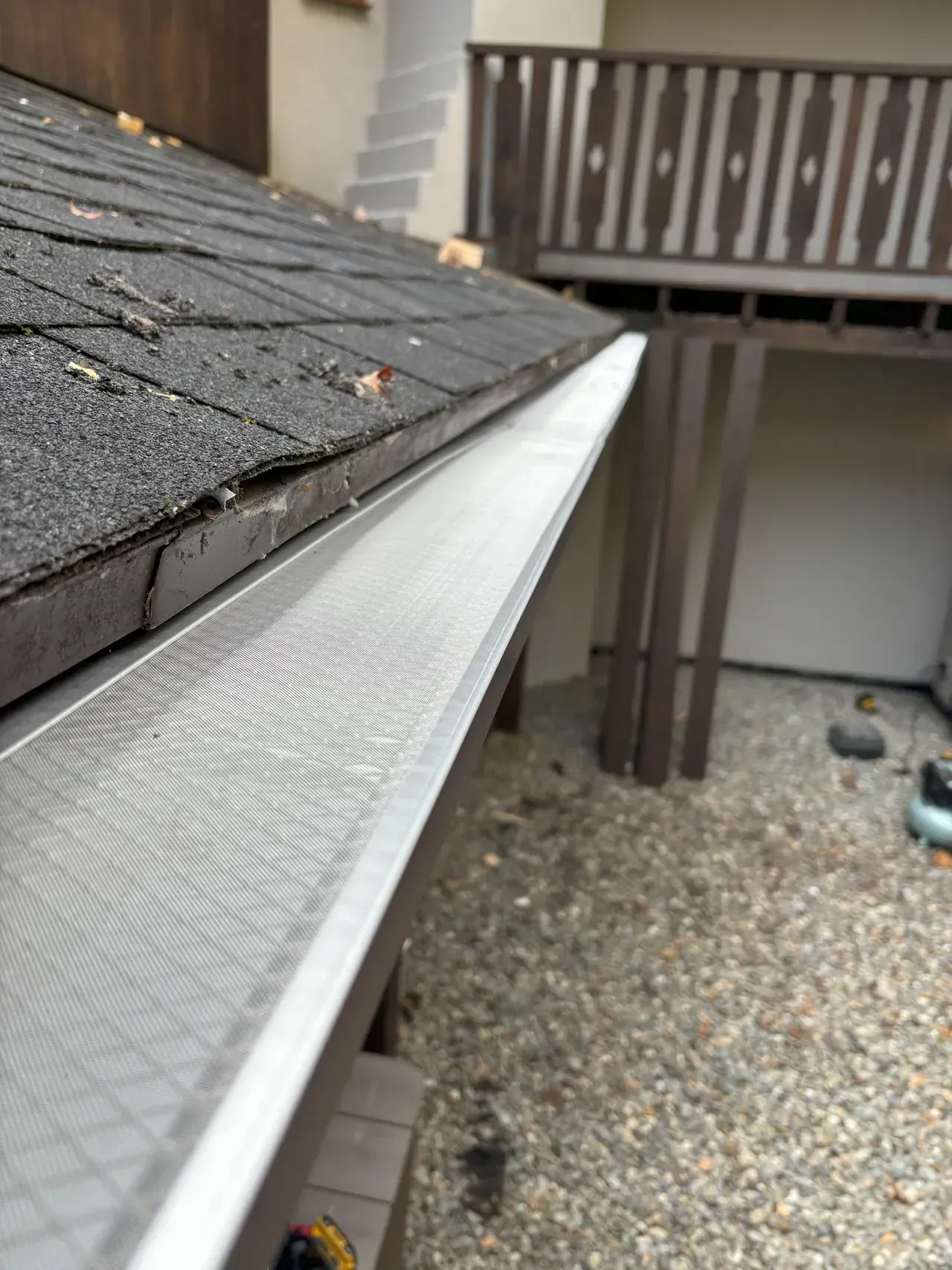 A close up of a gutter on the side of a house.