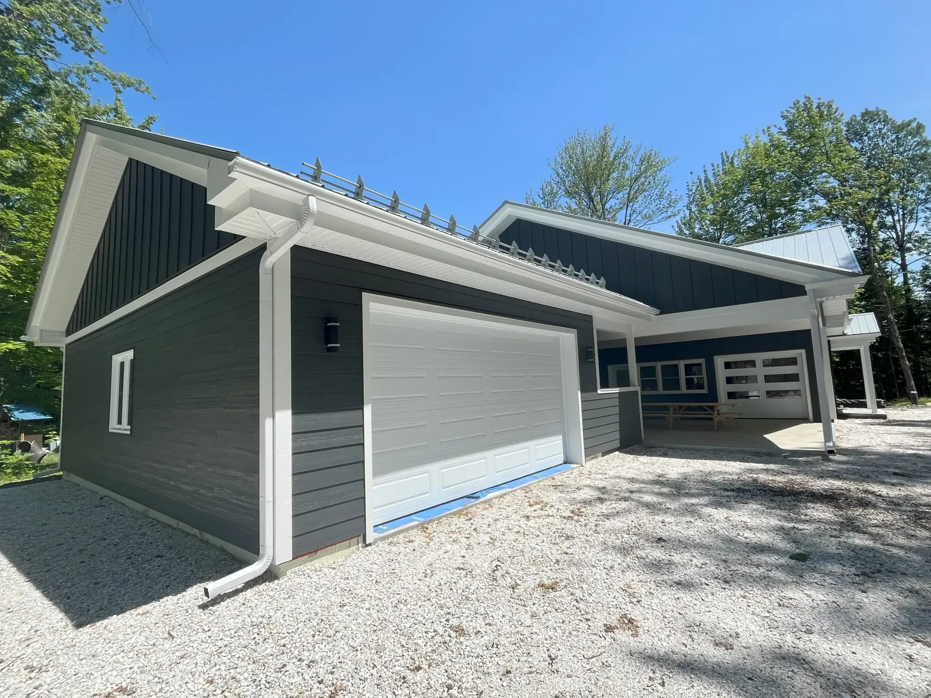 A house with a garage and a carport in front of it.