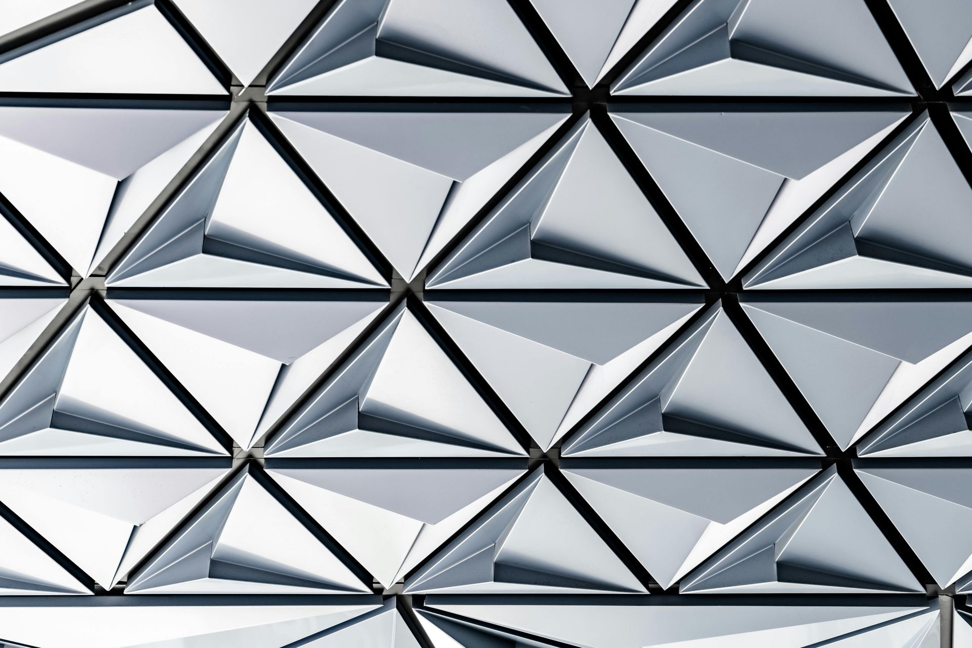 Geometric pattern of light gray triangular prisms.