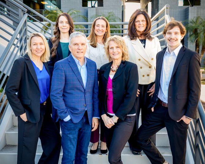 The Team at Cobb CPA pose on metal stairs.