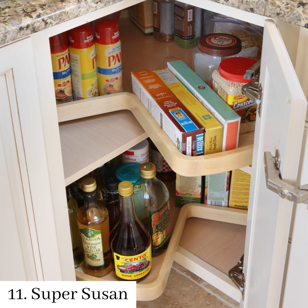 Kitchen cabinet with a super susan organizer holding cans, boxes, jars, and bottles of food items.