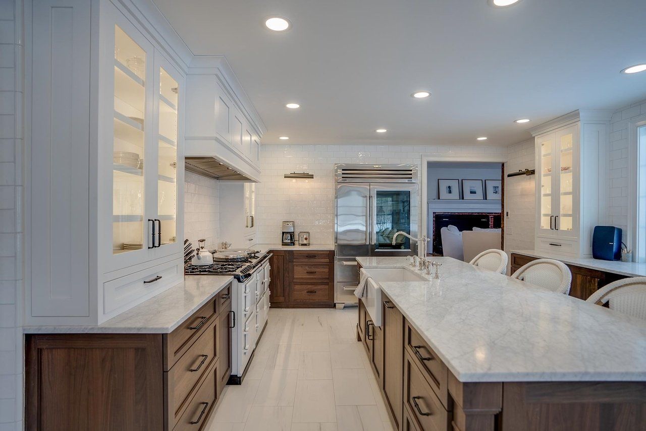 Bright modern kitchen with white cabinetry, large island, and stainless steel appliances