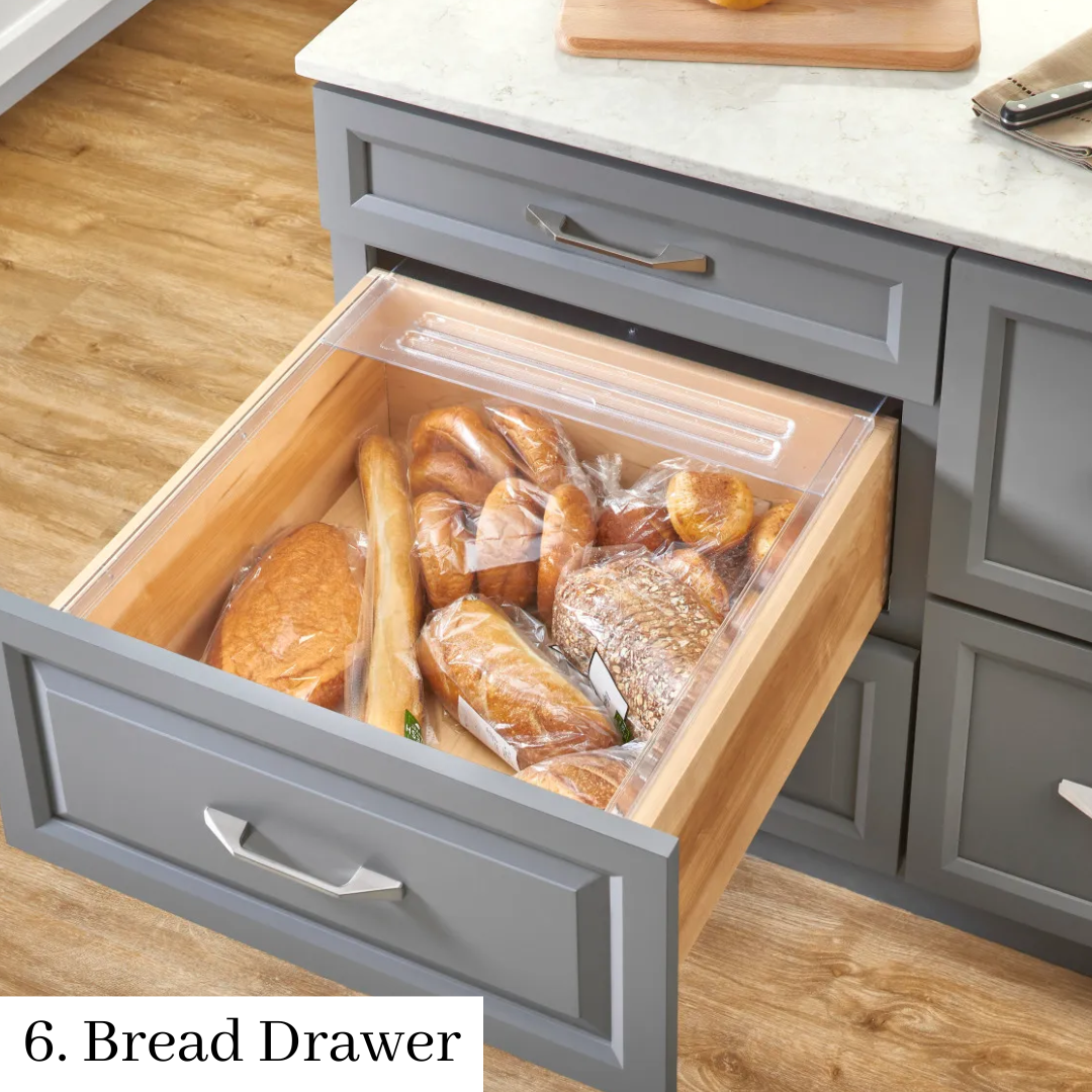 Open kitchen drawer with bread loaves in a clear wooden bin