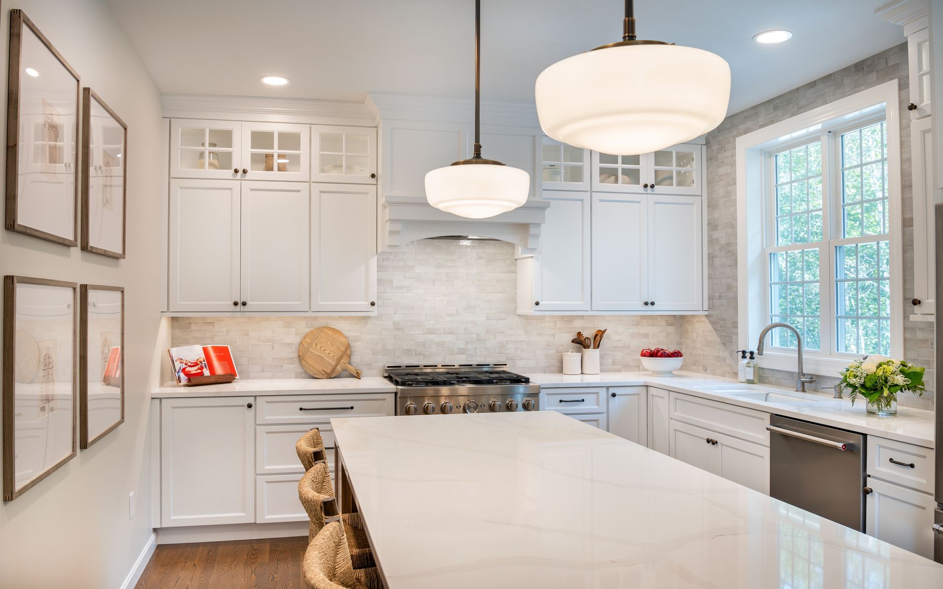 Bright white modern kitchen with large island, pendant lights, and stainless steel appliances