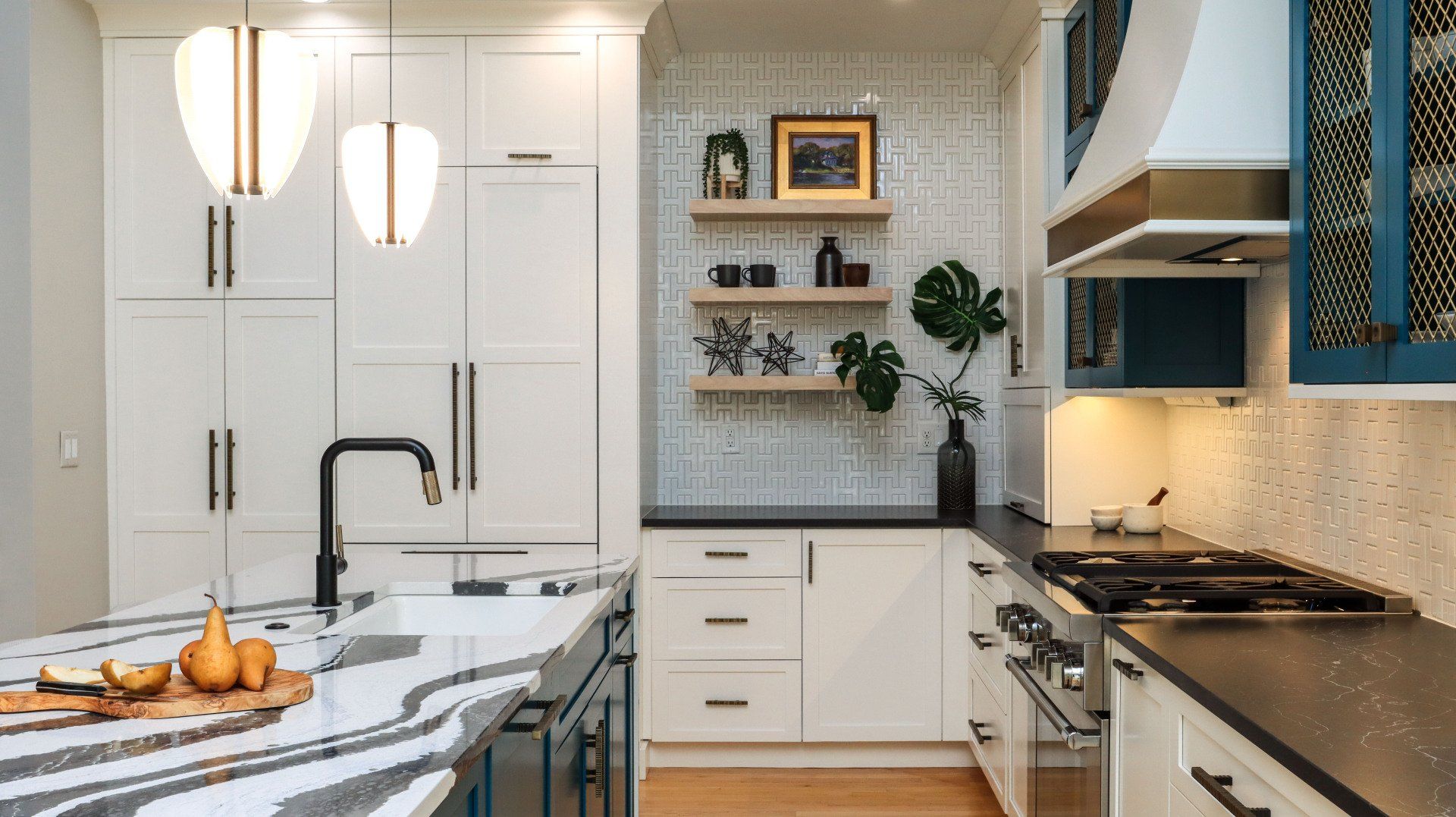 Bright modern kitchen with white cabinets, marble island, black fixtures, and blue backsplash accents