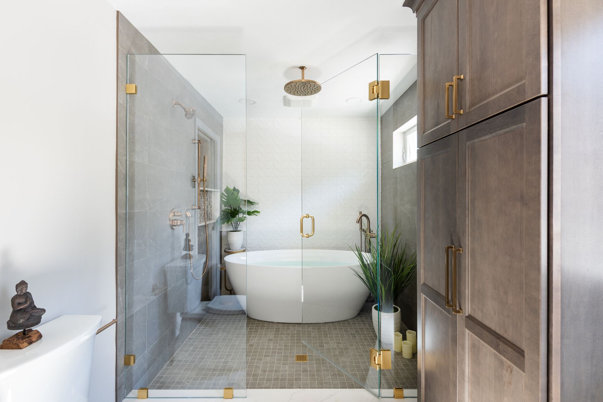 Bright modern bathroom with a freestanding tub, glass shower, and wood cabinetry