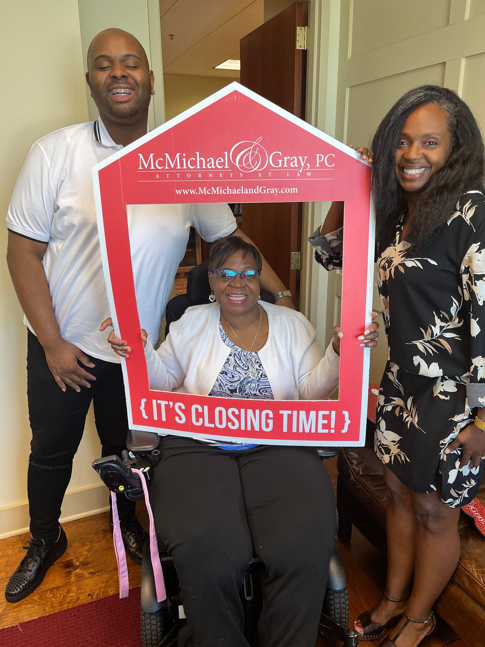 Rhonda Martin, Georgia Realtor with her client and her lender with a house-shaped frame that says