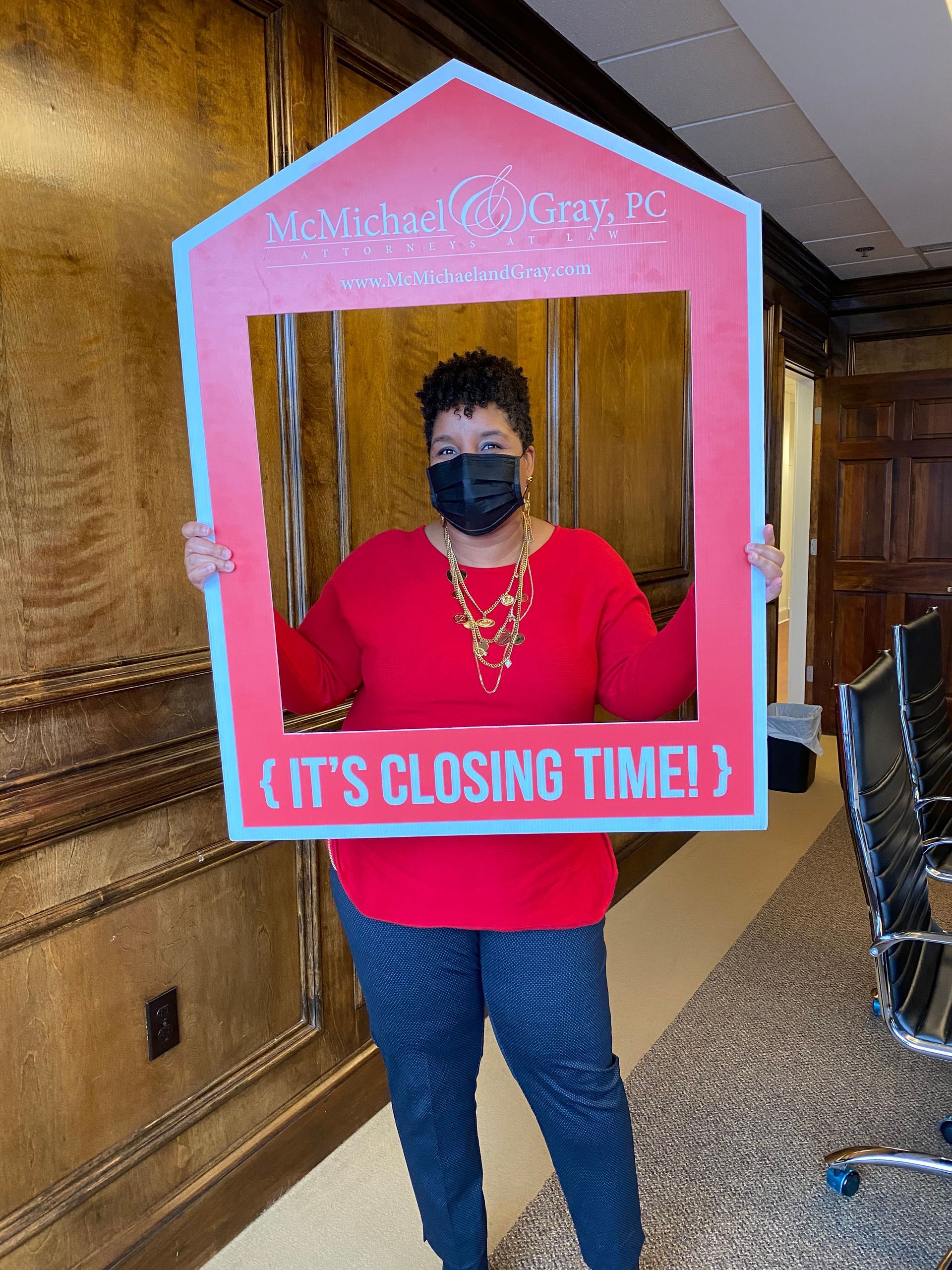 Rhonda Martin, Georgia Realtor client in red sweater and mask holds a