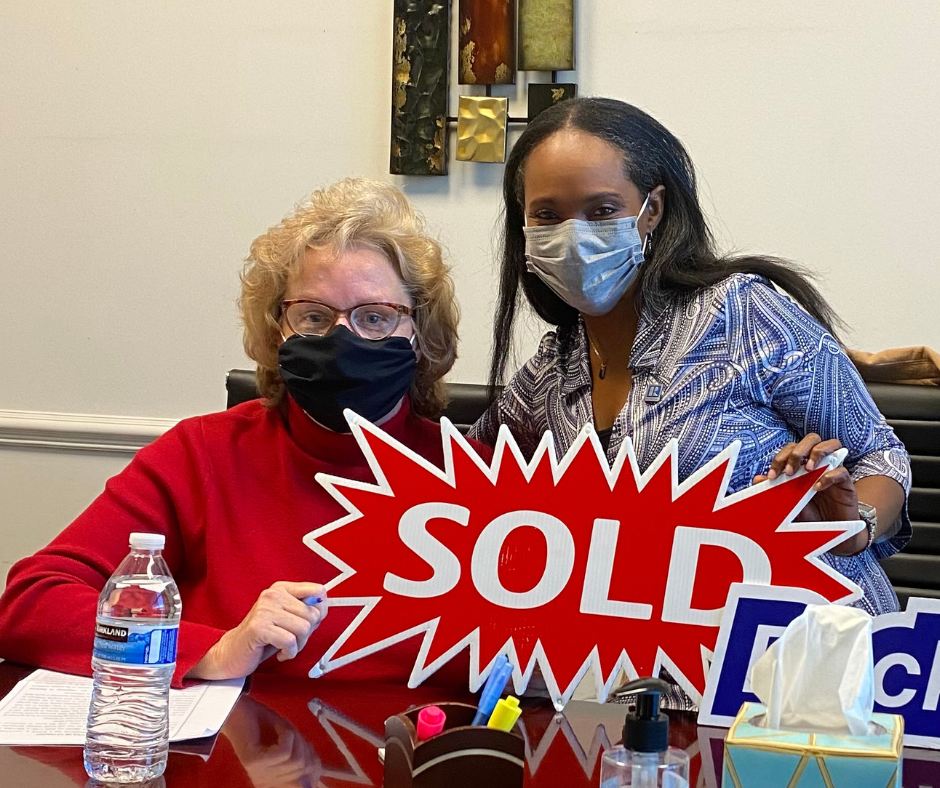 Rhonda Martin, Georgia Realtor with her client holding a