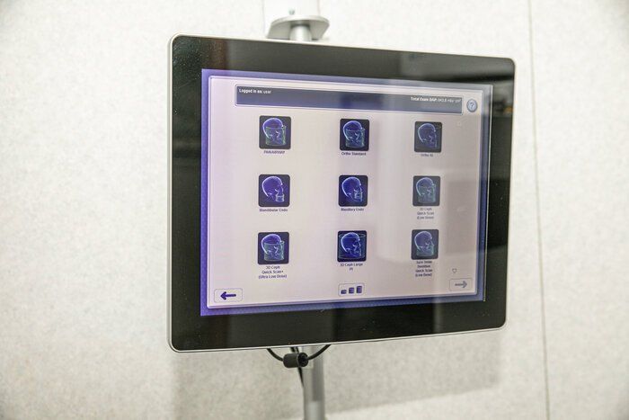 A computer monitor is sitting on a stand on a wall.