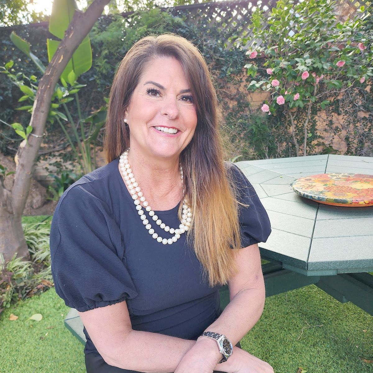 Kari Negri | Founder & CEO corporate photo of SKY Properties CEO and president dressed in sky blue business attire