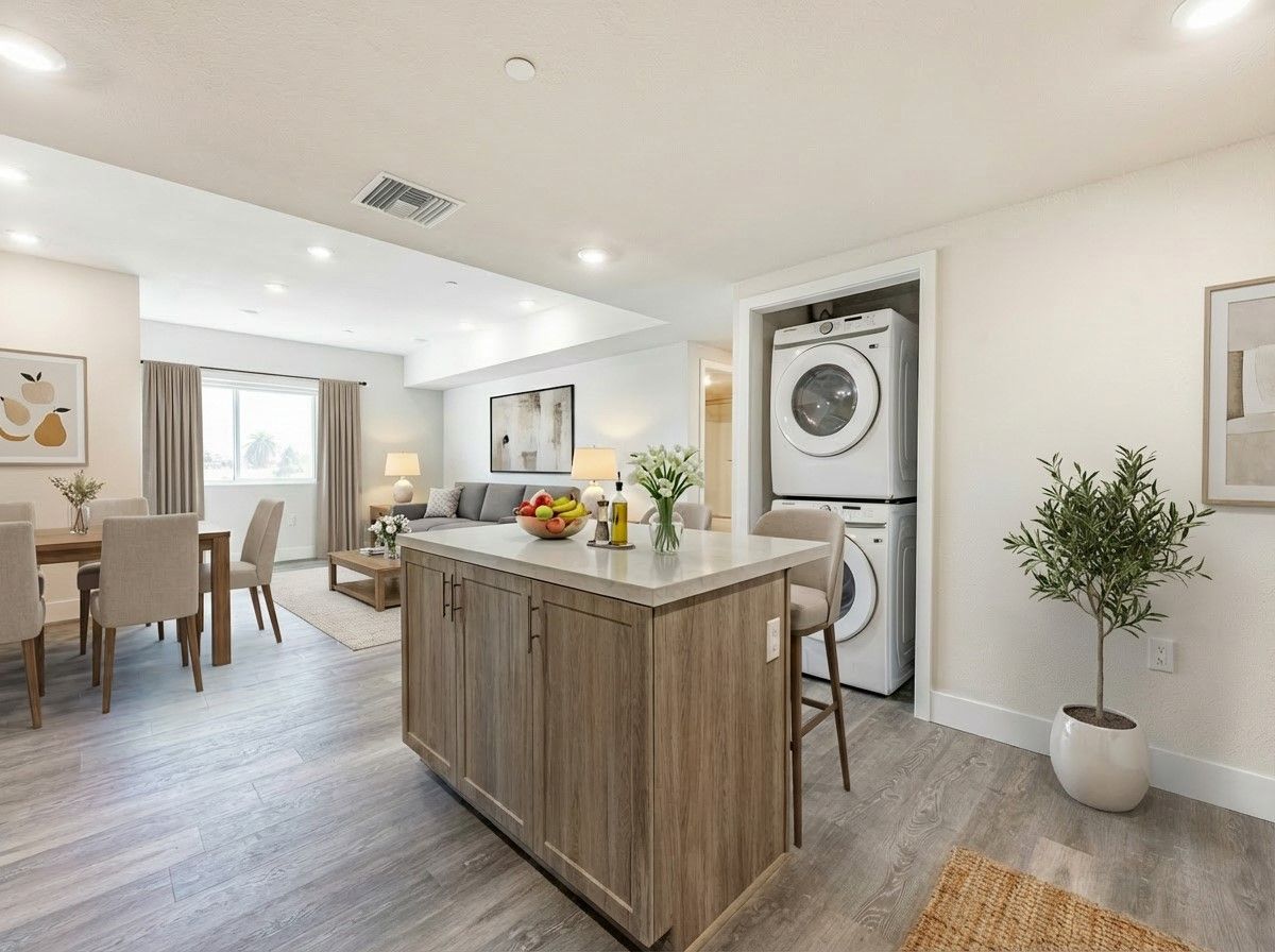 The Secret in K-Town Luxury Apartments ' kitchen, spacious and bright living area and view of the in-unit washer and dryer