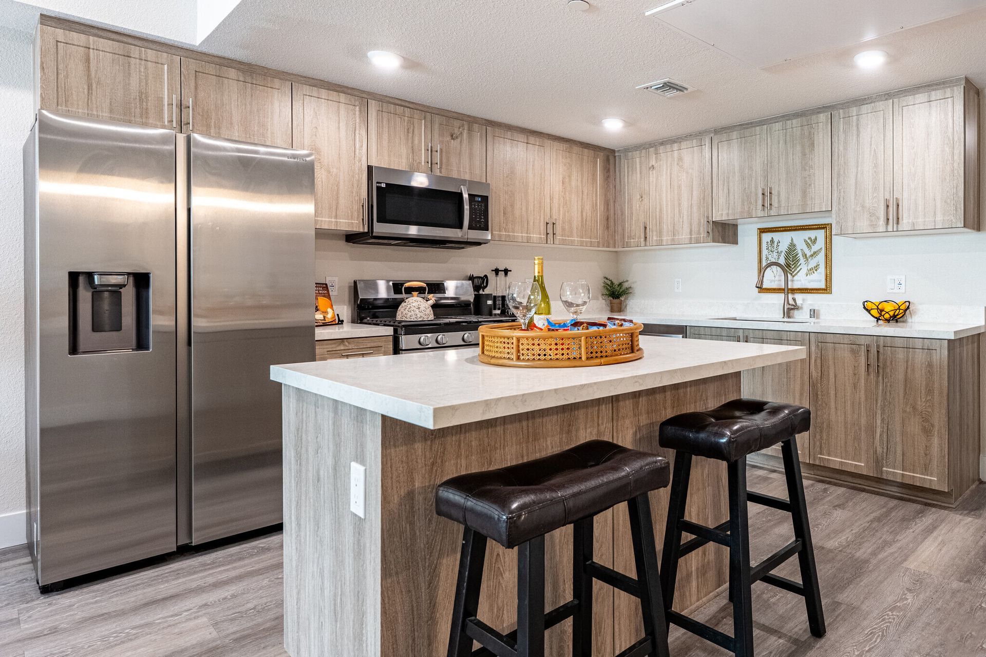 Open kitchen design with ample cabinetry and modern lighting at The Secret at K-Town Luxury Apartments in Los Angeles