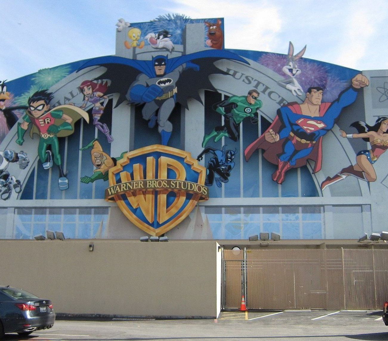 exterior photo showing superhero visual blow-ups on the building facade of the warner bros studios