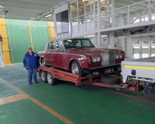 A Tow Truck Is Towing a Car on A Highway — Ballarat Trailer Hire in Alfredton, VIC
