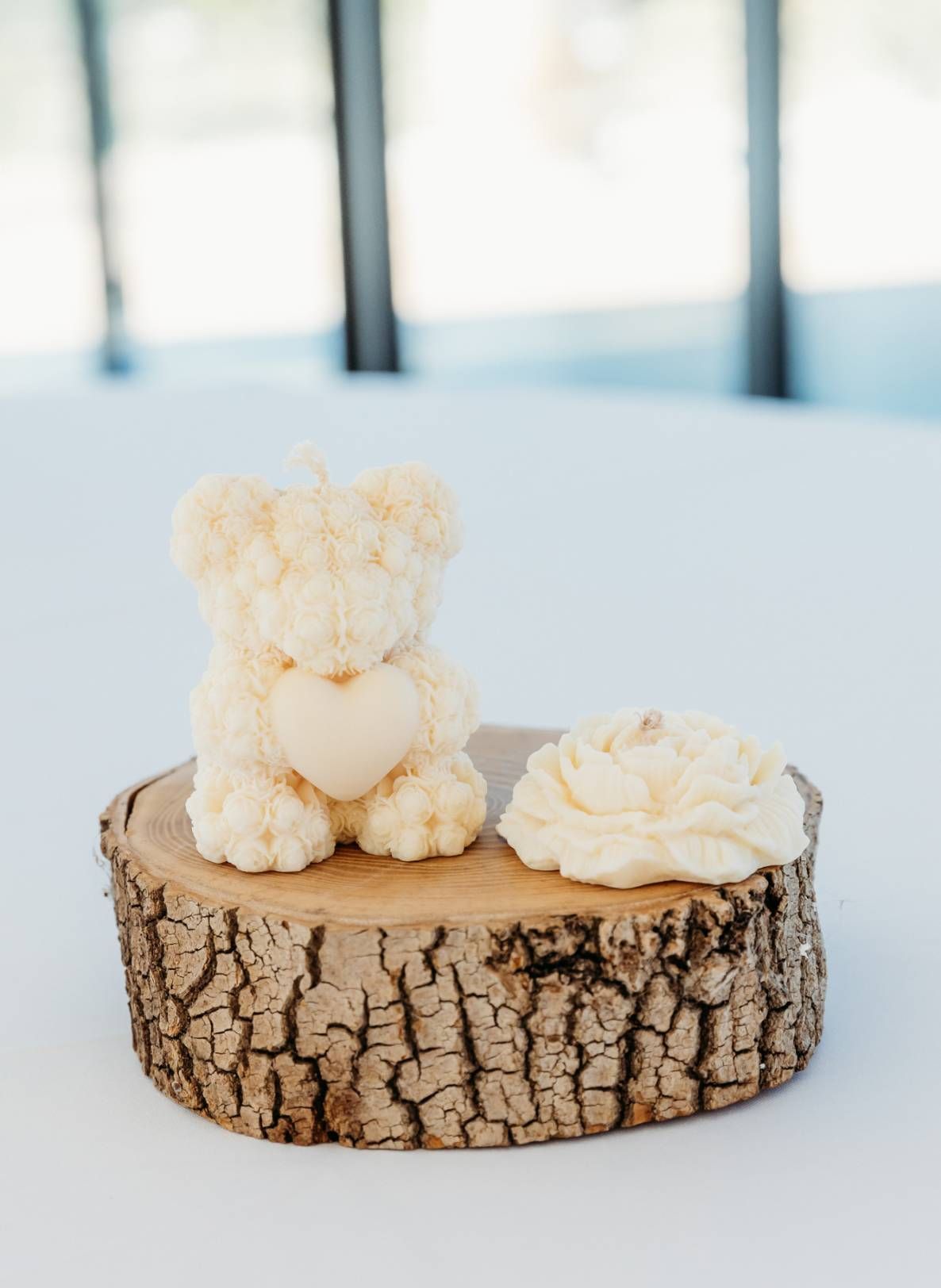 Un ours en peluche est assis au sommet d'une souche de bois.