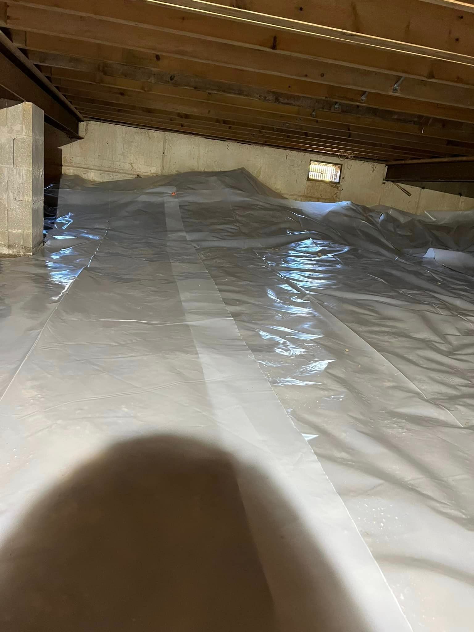 A basement with a lot of plastic covering it.