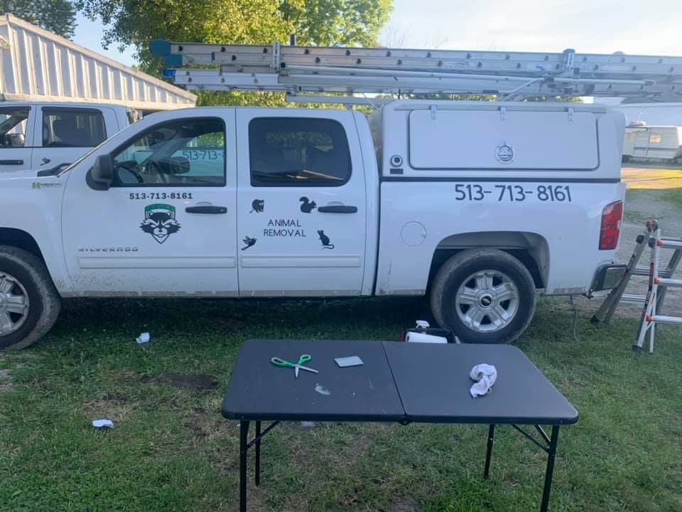 A white truck with a black table in front of it.
