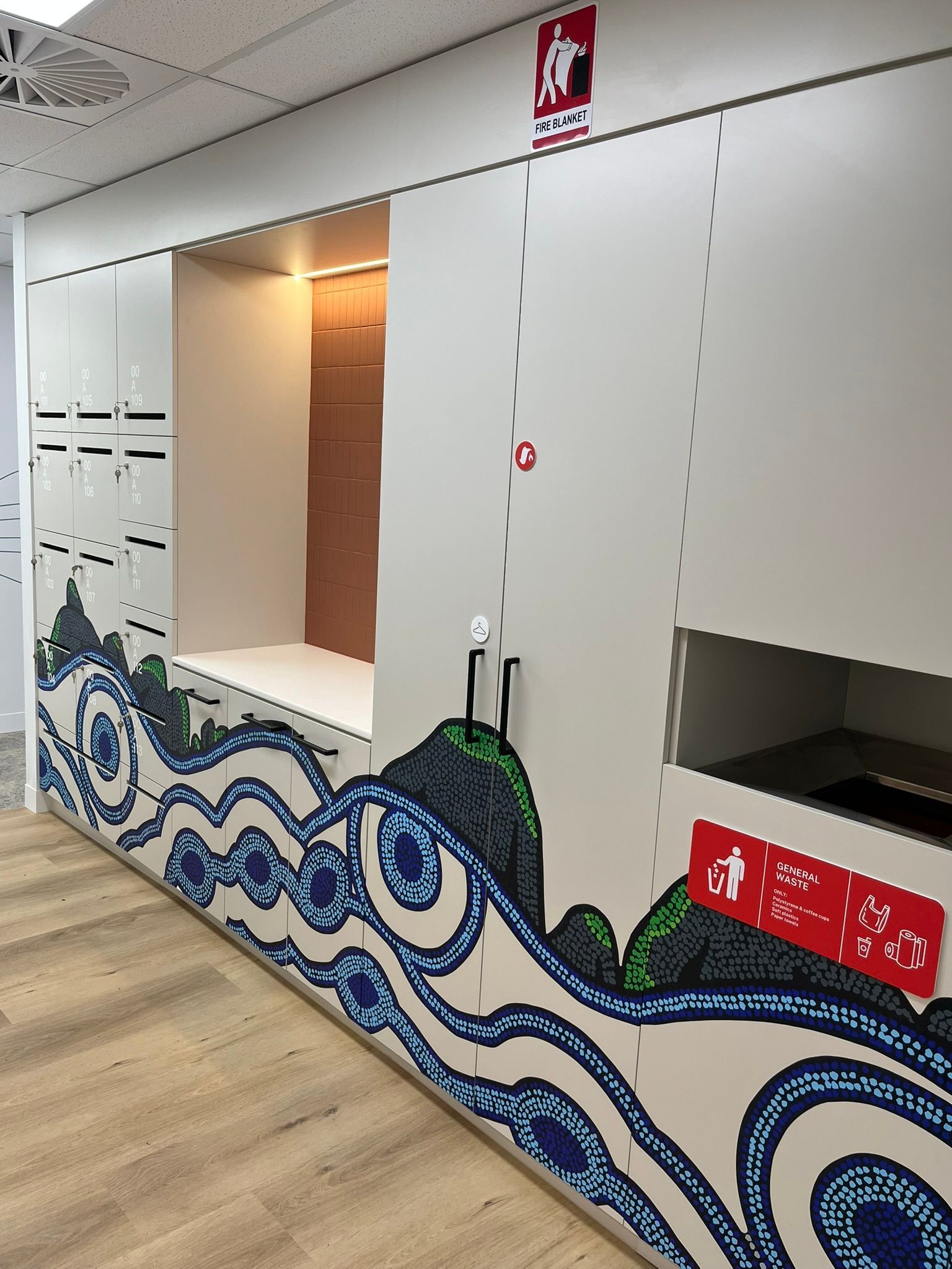 White Wall with Two Openings, Wave Mural, and Red Safety Signs — Zeal Interiors & Joinery in South Grafton, NSW