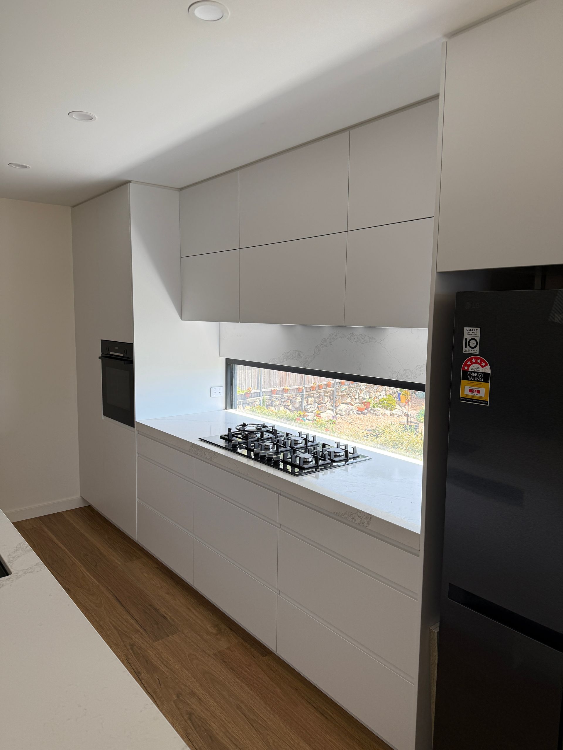 Modern White Kitchen with Built-In Appliances — Zeal Interiors in Sydney, NSW