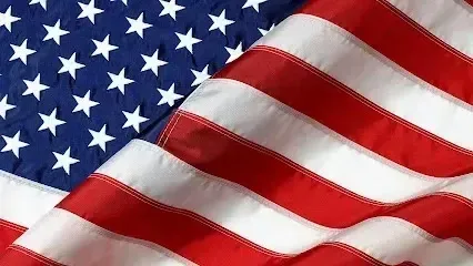 Chimney sweep Portland Maine -Close-up of the rippling US flag with its blue field of stars and red and white stripes.