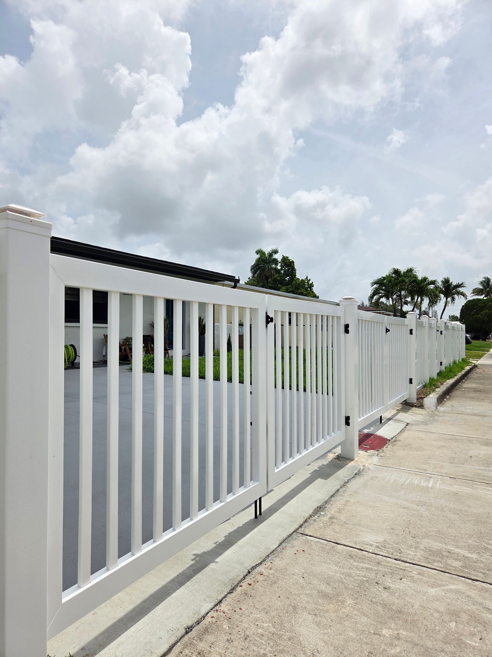 White picket fence with gate on a sunny day.