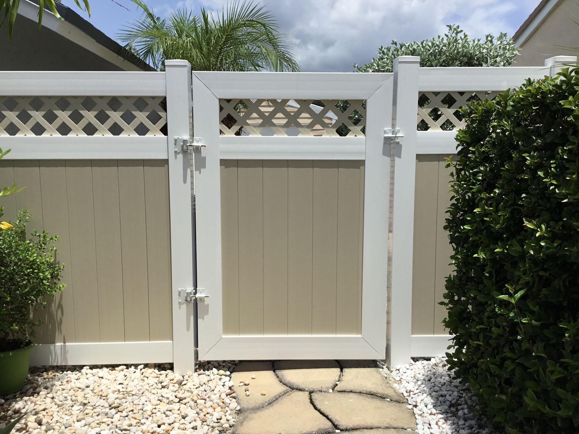 A white fence with a gate in the middle of it