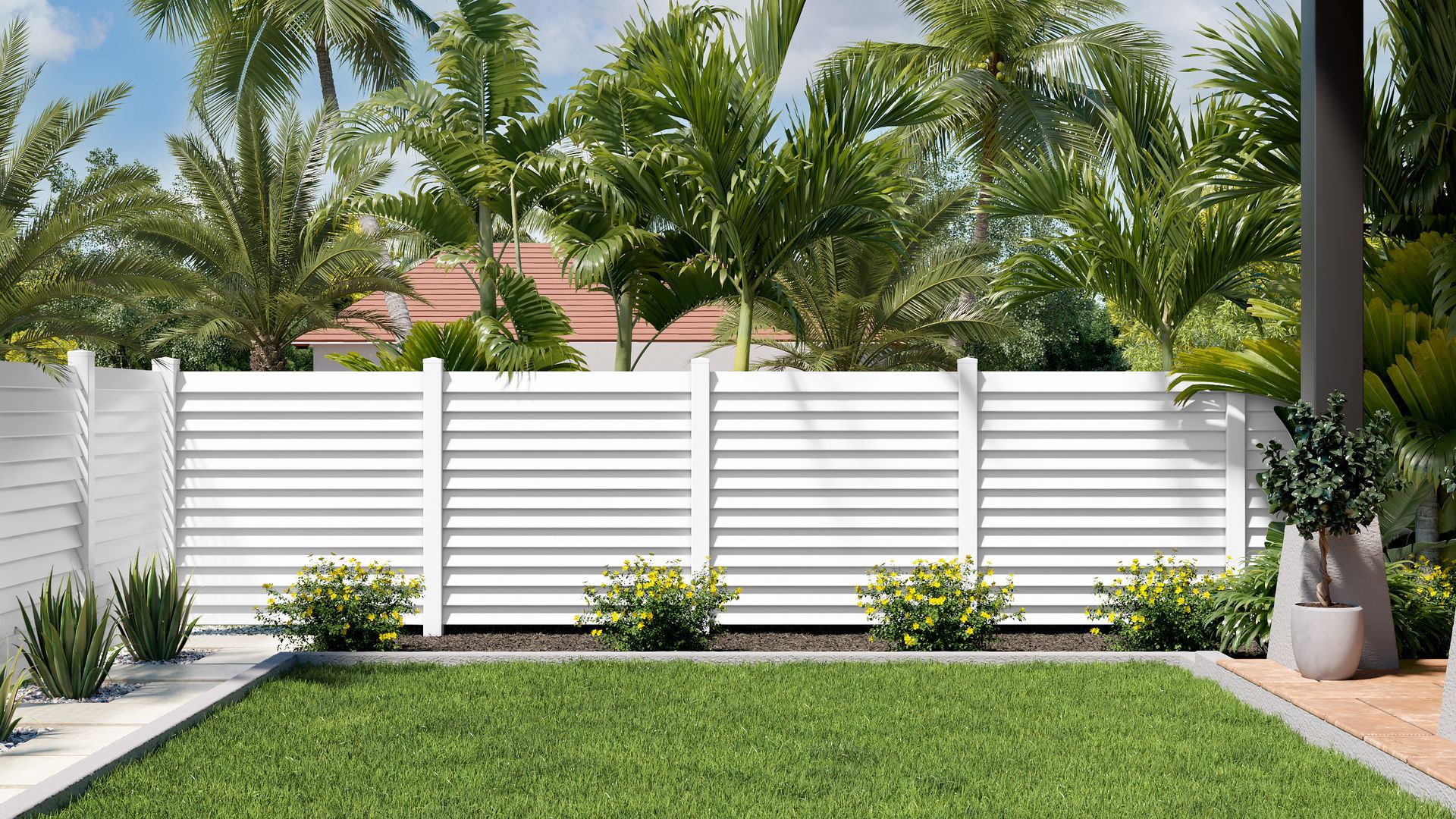 White horizontal slat fence in a grassy yard, surrounded by green shrubs and palm trees.