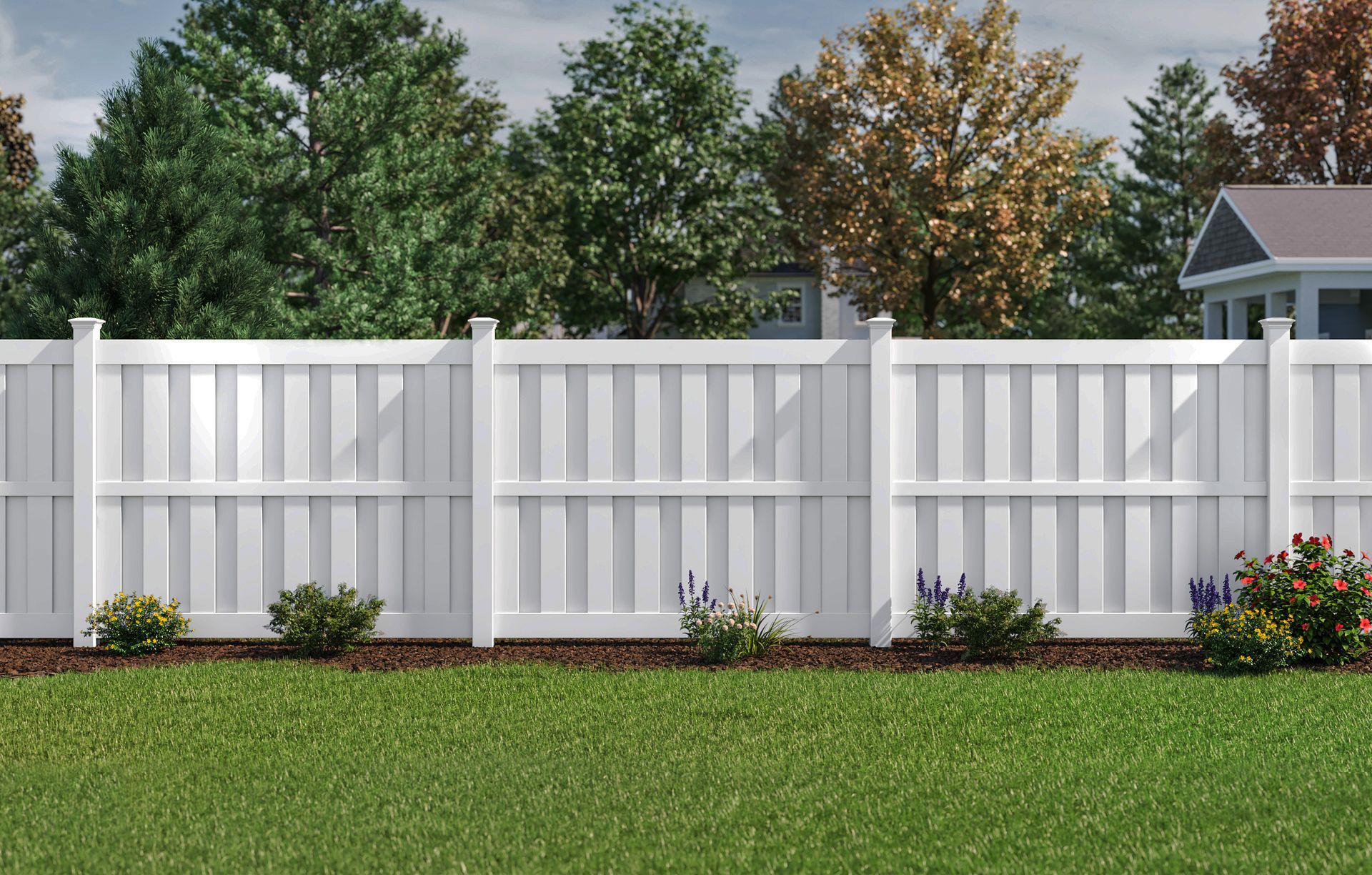 White vinyl fence in a grassy yard, with trees and a house in the background.