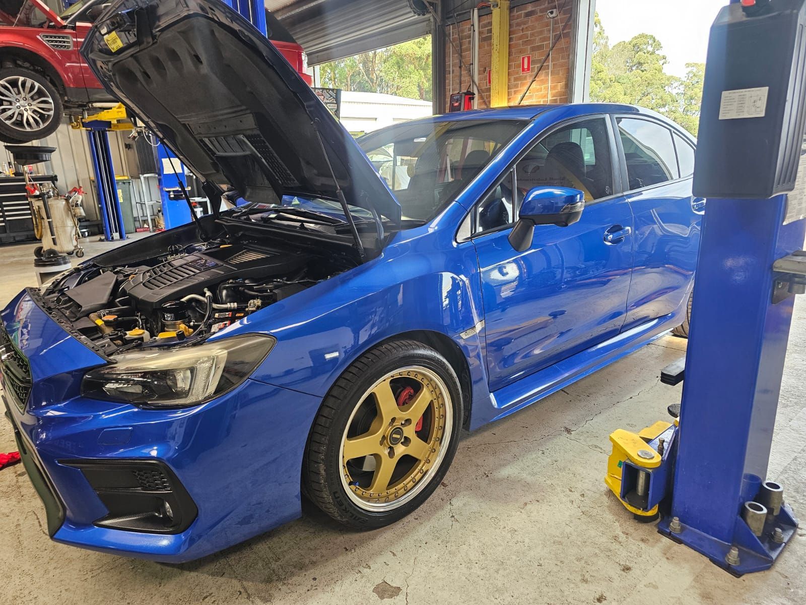 Blue Sedan With Hood Open in an Auto Repair Shop — AA Automotive Repairs in Forster, NSW
