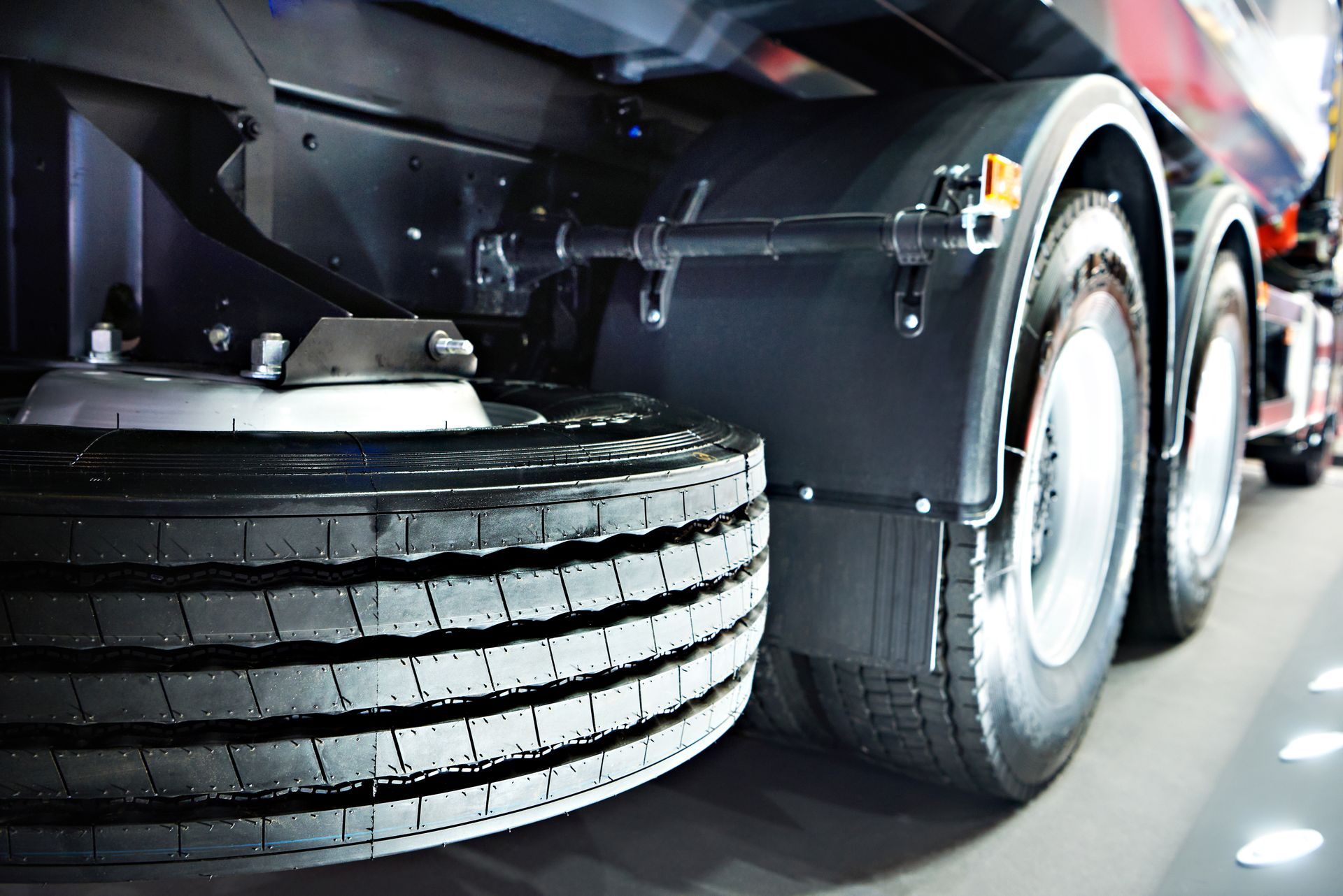 Close-up of a truck’s rear wheels and tire tread on a road