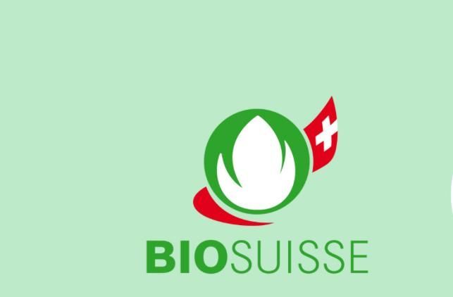 Logo BIO SUISSE su sfondo verde chiaro con il simbolo della croce svizzera rossa.