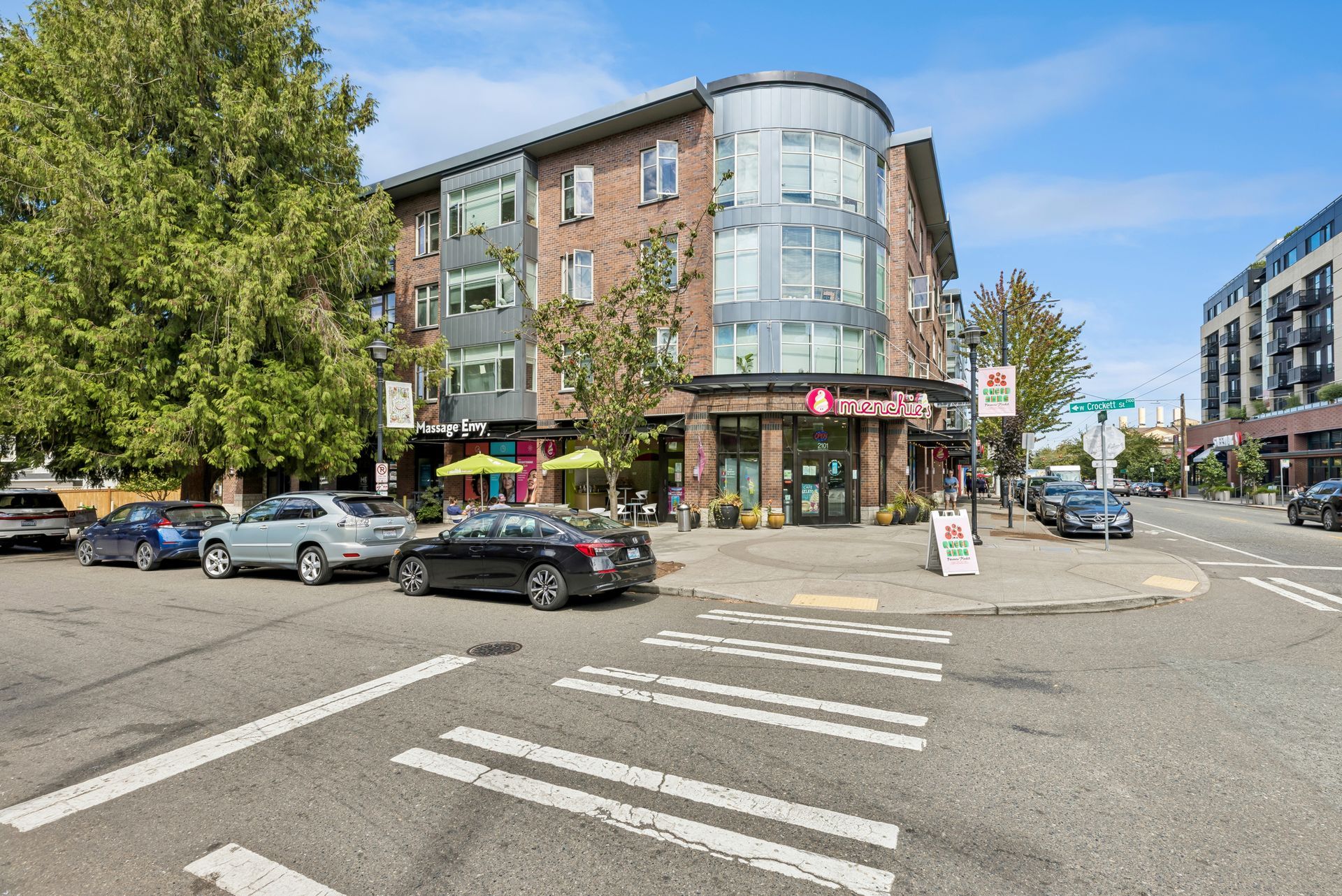 Sweetbrier apartment building on street corner with parked cars