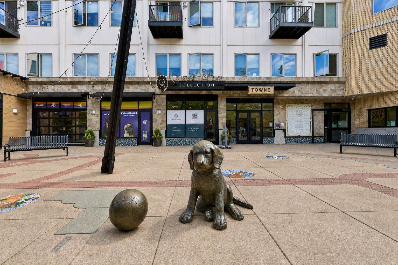 Statue of puppy and ball outside of Towne apartment building