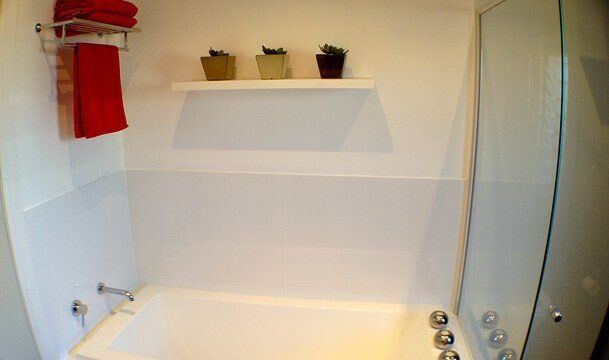 Modern Bathroom with Red Towels — Craig Allman Construction Pty Ltd In Fernhill, NSW