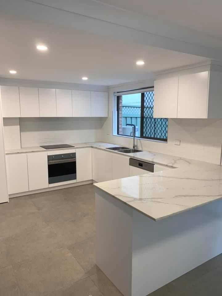 A Kitchen With White Cabinets — Craig Allman Construction Pty Ltd In Fernhill, NSW