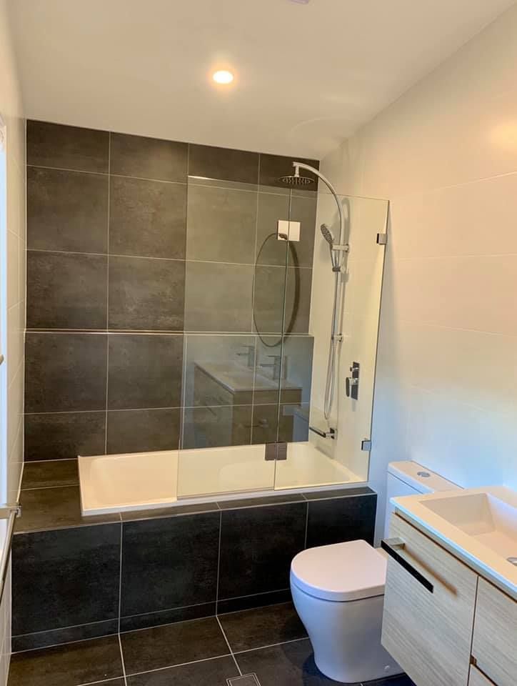 A Bathroom With a Bathtub, Toilet, Sink and Shower — Craig Allman Construction Pty Ltd In Fernhill, NSW