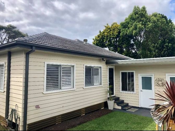 A White House With a Gray Roof and Shutters on the Windows — Craig Allman Construction Pty Ltd In Fernhill, NSW
