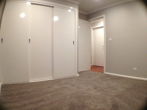 Carpeted Bedroom with White Walls — Craig Allman Construction Pty Ltd In Fernhill, NSW