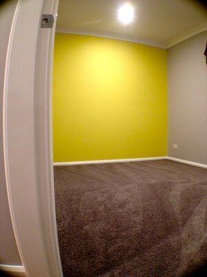 Bedroom with Yellow Feature Wall — Craig Allman Construction Pty Ltd In Fernhill, NSW
