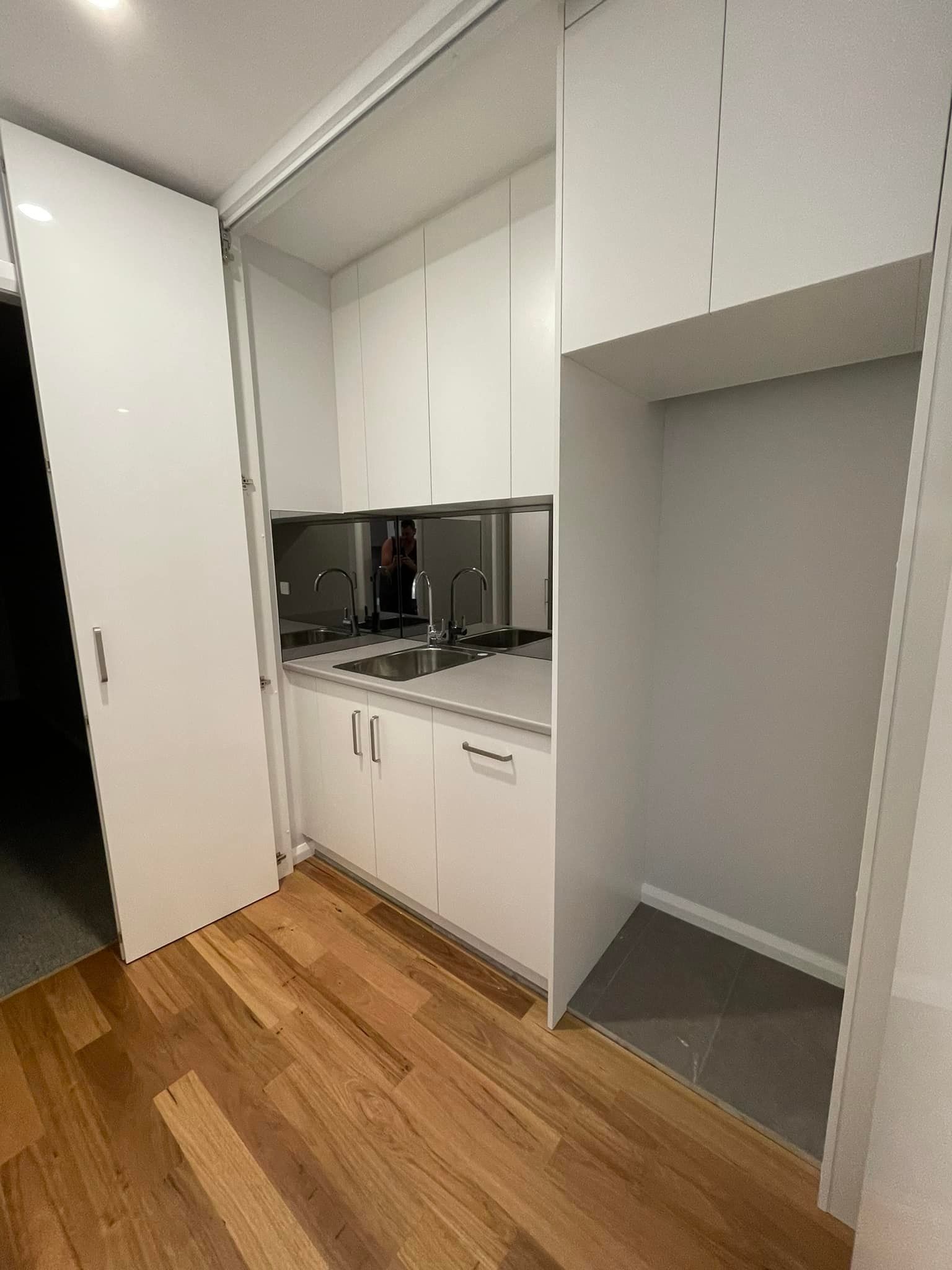 A Kitchen With White Cabinets and Wooden Floors — Craig Allman Construction Pty Ltd In Fernhill, NSW